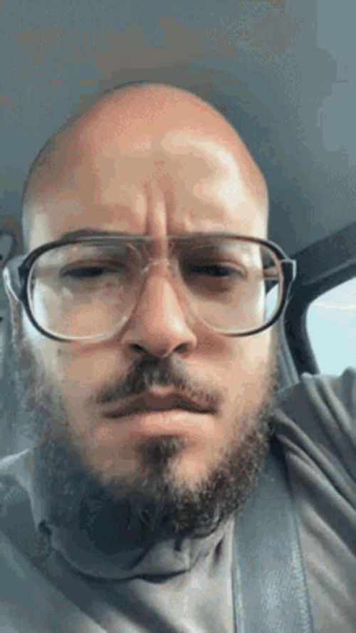 Goose Wayne wearing glasses in a car