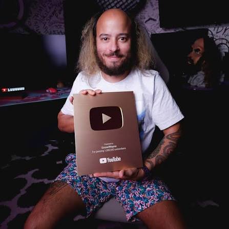 Goose Wayne holding a YouTube creator award