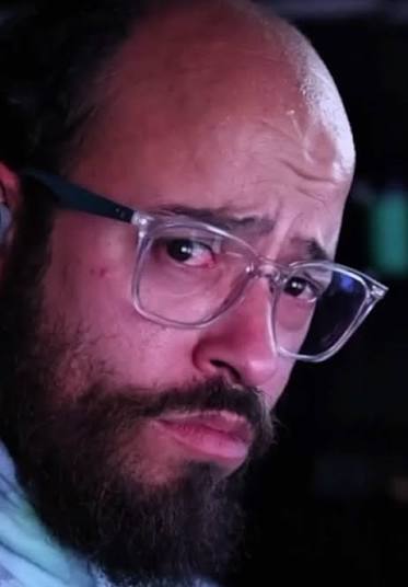 Goose Wayne wearing glasses at night